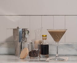 Espresso martini in a glass with ingredients nearby