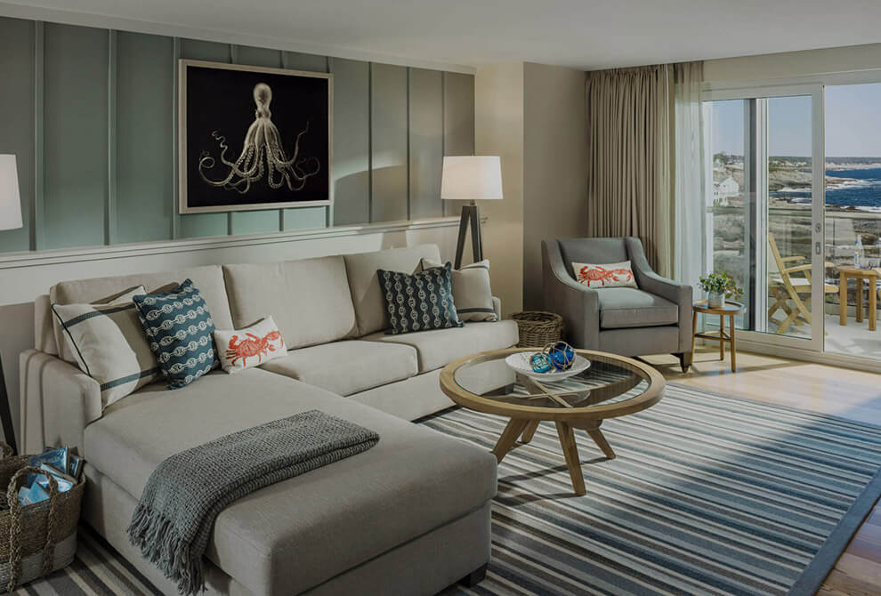 Lounge area with a large cozy couch and an ocean view