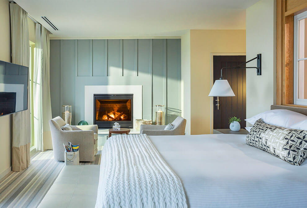 King bed room with a tv and a fireplace