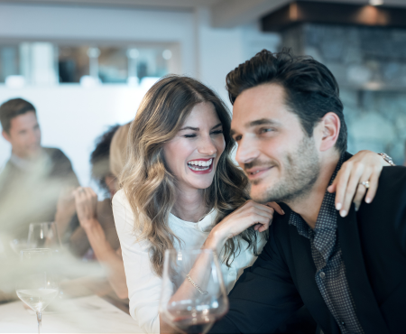 A couple smiling together while dining